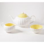 A Susie Cooper three piece teaset, white flute design with yellow interior and cover to teapot.