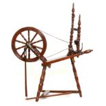 Painted beech spinning wheel, height 104cm.