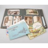 An album of postcards, cigarette and trade cards, in albums, together with loose cards in tins.