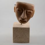 Inca death mask on a marble block plinth, overall height 40cm.