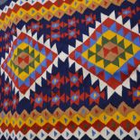 A modern Kelim rug, brightly coloured geometric pattern, 287cm x 119cm.