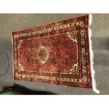 Small Hamadan rug, central medallion, red ground, within gards, 165cm x 108cm.