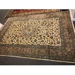 Kashan rug, central floral medallion, pale ground, with allover floral design, broad border,