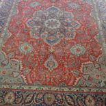 Persian pattern carpet, central blue ground medallion, on red field, within gards,