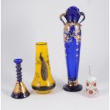 Pair of amethyst tinted cut-glass candlesticks, 98cm; and a small collection of coloured glassware.