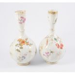 Pair of Limoges porcelain bottle vases, wrythen moulded and printed with flowers, 23cm.