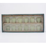 Set of twelve celadon coloured jade wine cups, flare form, 4cm, in a fitted case.