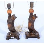 Pair of carved 'Black Forest' table lamps, designed with bears, height to top of frames 58cm.