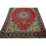 Large Iranian carpet, central medallion against a crimson ground,
