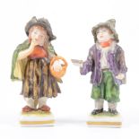 Pair of German porcelain figures, girl with a basket, and a boy with a bowl, under-glazed blue mark,