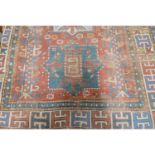 Antique Caucasian Kajk rug, red ground with three medallions, geometric borders, 192cm x 148cm.