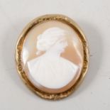 An oval carved shell cameo brooch, female profile facing right, 32mm x 29mm, in a gold-plated frame,