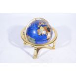 A contemporary table globe, hardstone effect on a brass frame, 43cm.