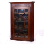 George III mahogany hanging corner cabinet, cavetto moulded cornice, inlaid frieze,