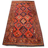 Persian pattern rug, tiled field, red and blue ground, meandering borders, 284cm x 158cm.