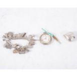 A silver charm bracelet, twenty charms attached, a 35mm heart shaped pendant,