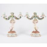 A pair of Derby style two-light candelabra, scrolled branches with encrusted flowers,