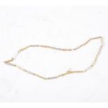 A yellow and white metal necklace,