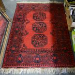 Bokhara rug, red ground, with medallions, tiled border, width 108cm, length 153cm.