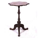 Victorian walnut tripod table, shaped top with a carved edge,