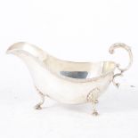 A silver sauce boat, gadroon edge design on three shell and hooved feet, hallmarked Birmingham 1937,