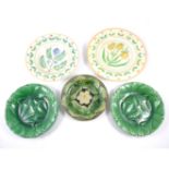 Two green glazed leaf moulded pottery dishes, three similar plates,