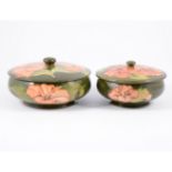 Two Moorcroft "Hibiscus" lidded powder bowls, green ground, 17cm and 14cm.