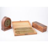 Three cases of microscope slides, cased set of instruments, dial gauge and metal samples.