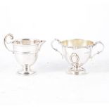 A silver cream jug and small twin handled bowl,