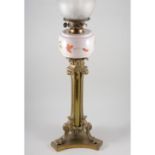 Edwardian brass tripod lamp base, adapted with a later oil lamp reservoir, shade and funnel,