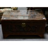 Singapore camphor chest, carved with Chinese scenes, with glass top, 73cm x 37cm, height 38cm.