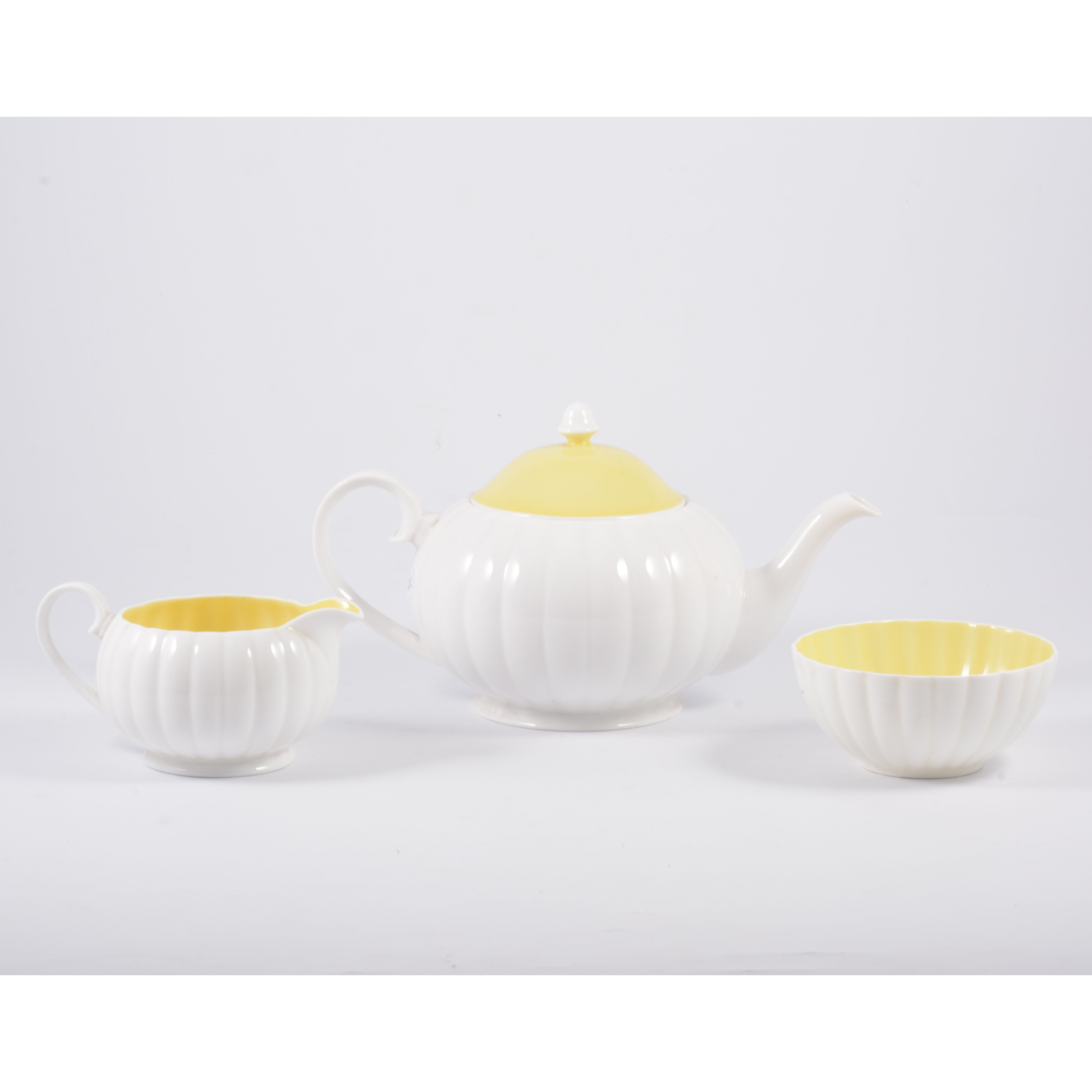 A Susie Cooper three piece teaset, white flute design with yellow interior and cover to teapot. - Image 3 of 3