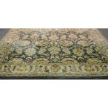 A contemporary wool carpet, muted blue/turquoise ground with natural coloured foliate design,