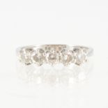 A diamond five stone ring, five brilliant cut diamonds claw set in a platinum half hoop mount,