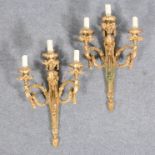 A pair of Louis XV style gilt metal three-light sconces, 20th Century, flaming swagged urn finials,