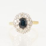 A sapphire and diamond oval cluster ring, the oval mixed cut sapphire 6.5mm x 5.