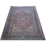 Tabriz pattern carpet, central medallion on a patterned floral red ground field, worn,