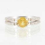 A yellow sapphire and diamond ring, a 5.