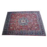Tabriz pattern carpet, central medallion on a trellised and floral pattern red field, worn,