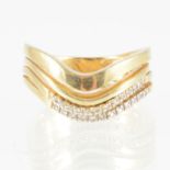 A diamond set dress ring, a contemporary design of four yellow metal curved bands,