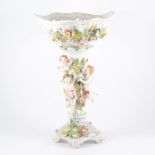 Dresden porcelain Comport decorated with encrusted flowers and having three Cherubs around stem,