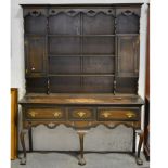 Oak dresser, 20th Century, cavetto moulded cornice, panelled back with fixed shelves and cupboards,