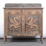 Carved oak cupboard, rectangular top with shallow back, the front with drawers above doors,