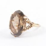 A vintage smoky quartz dress ring, the oval mixed cut stone 22mm x 15mm,