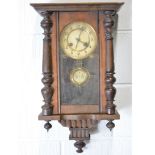 An oak cased Vienna type wall clock, Arabic dial with pendulum, 59cm.