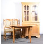 Modern light oak dining table, circular extending top with a moulded edge, plain frieze,