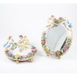 Pair of Dresden porcelain table mirrors, oval frames, mounted with cherubs and encrusted flowers,