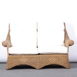 Rattan cane two seater sofa and armchair, with cream cushions, length 147cm, depth 94cm,