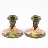 Pair of Moorcroft dwarf candlesticks, Hibiscus...