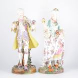 A pair of German porcelain figures, lady and...